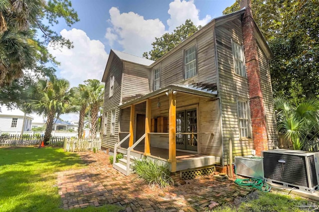 exterior space featuring central AC unit and a lawn