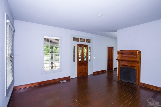 unfurnished living room featuring dark hardwood / wood-style flooring