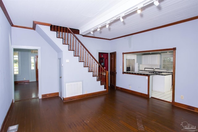 interior space with ornamental molding, hardwood / wood-style floors, and track lighting