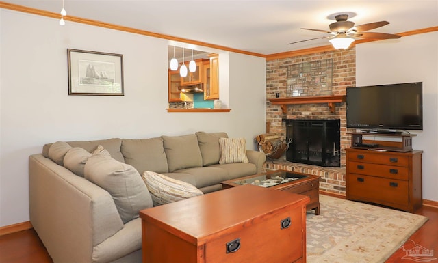 1609 N Spring St, Pensacola, FL 32501 - living room featuring ceiling fan, wood finished floors, ornamental molding, a fireplace, and baseboards