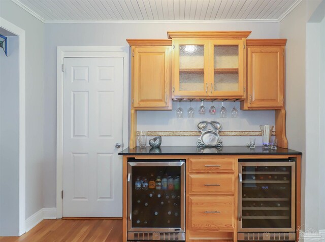 1609 N Spring St, Pensacola, FL 32501 - indoor dry bar featuring beverage cooler, wood finished floors, ornamental molding, and baseboards