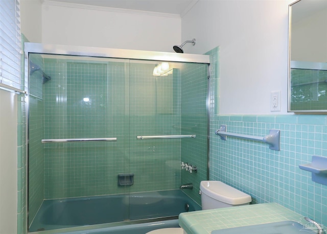 1609 N Spring St, Pensacola, FL 32501 - bathroom featuring toilet, crown molding, tile walls, enclosed tub / shower combo, and vanity