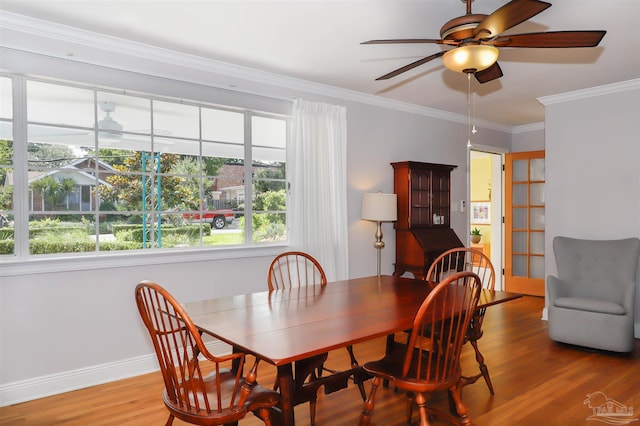 1609 N Spring St, Pensacola, FL 32501 - dining room featuring wood finished floors, a ceiling fan, crown molding, and baseboards