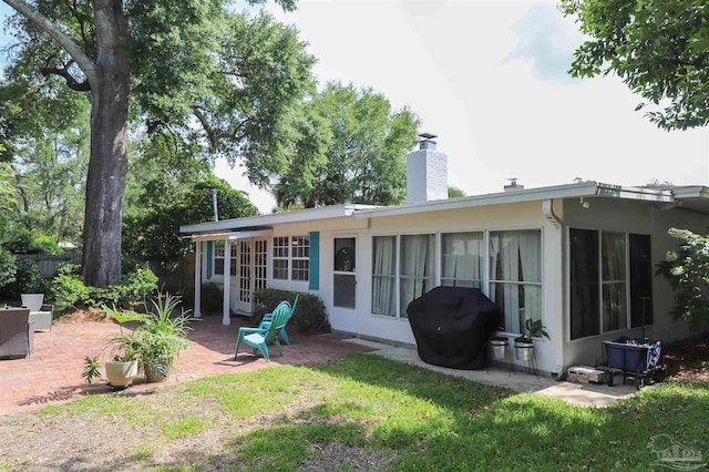 1609 N Spring St, Pensacola, FL 32501 - rear view of house featuring a patio, a chimney, and a yard
