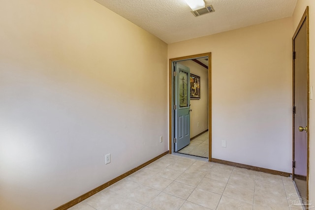 unfurnished bedroom featuring light tile patterned floors and a textured ceiling