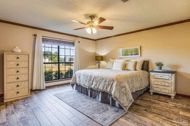 bedroom with ceiling fan, crown molding, wood-type flooring, and a textured ceiling