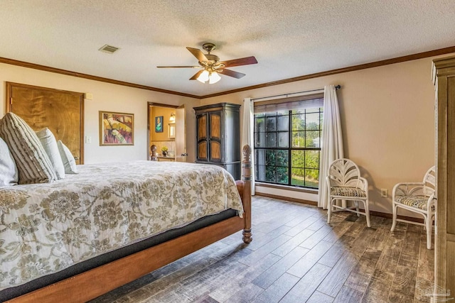 bedroom with a textured ceiling, ceiling fan, crown molding, and dark wood-type flooring