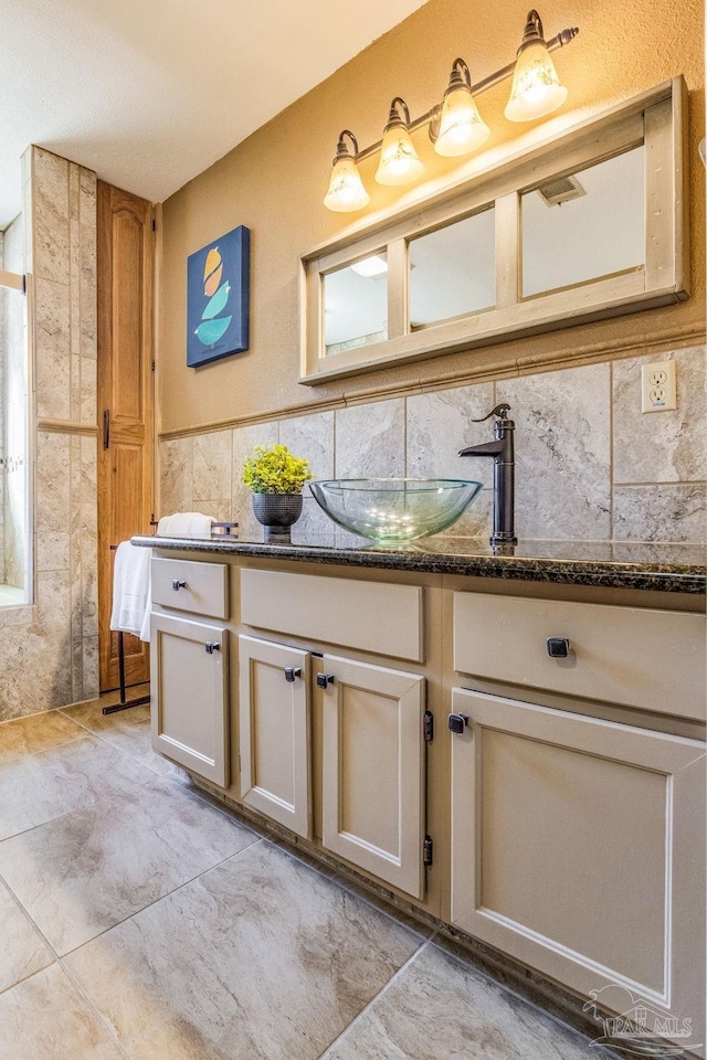 bathroom with decorative backsplash and vanity