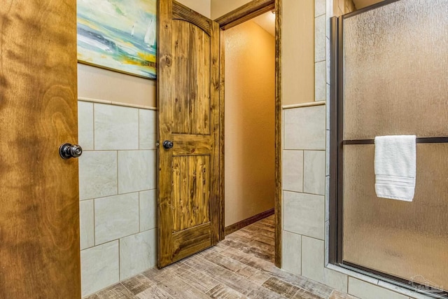 bathroom with walk in shower and hardwood / wood-style flooring