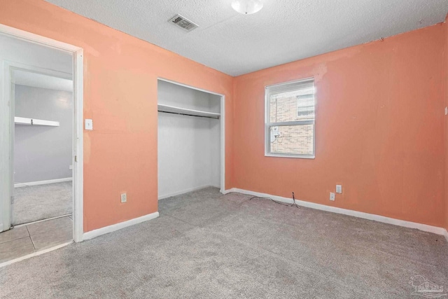 401 Ronda St, Pensacola, FL 32534 - unfurnished bedroom featuring a textured ceiling, carpet, baseboards, and a closet
