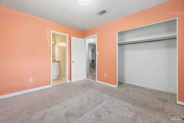 401 Ronda St, Pensacola, FL 32534 - unfurnished bedroom with a textured ceiling, carpet flooring, a closet, baseboards, and connected bathroom