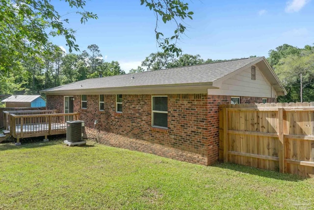 401 Ronda St, Pensacola, FL 32534 - back of house featuring central AC unit, brick siding, a deck, and roof with shingles