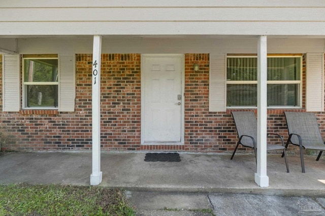 401 Ronda St, Pensacola, FL 32534 - property entrance featuring covered porch and brick siding