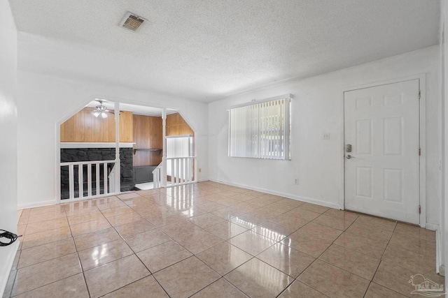 401 Ronda St, Pensacola, FL 32534 - tiled empty room featuring ceiling fan, a textured ceiling, and baseboards