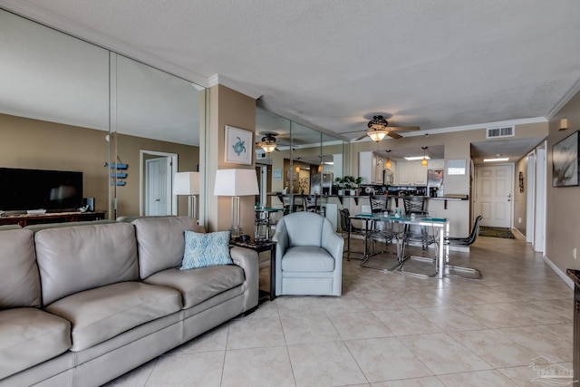 13817 Perdido Key Dr Unit 703, Pensacola, FL 32507 - tiled living room with ceiling fan, ornamental molding, and a textured ceiling