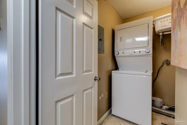 13817 Perdido Key Dr Unit 703, Pensacola, FL 32507 - laundry room featuring stacked washer and dryer, light tile patterned floors, and electric panel