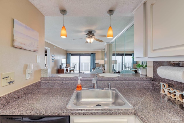 13817 Perdido Key Dr Unit 703, Pensacola, FL 32507 - kitchen with crown molding, sink, a textured ceiling, and white cabinets