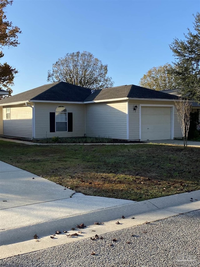 single story home with a garage and a front yard