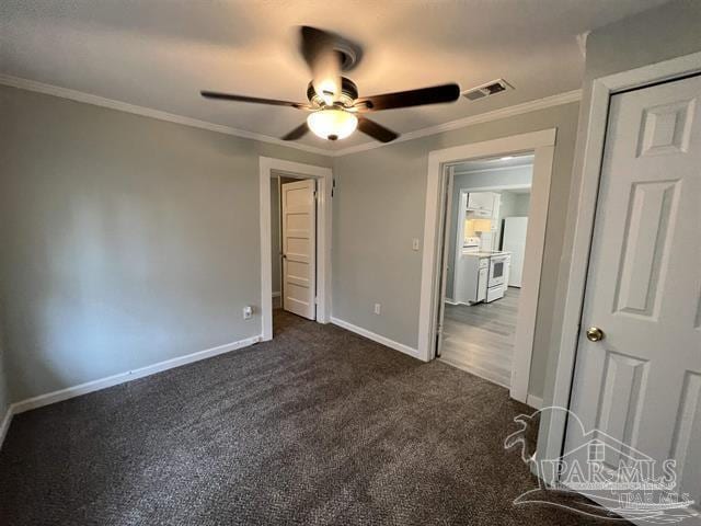 unfurnished bedroom with crown molding, ceiling fan, and dark colored carpet