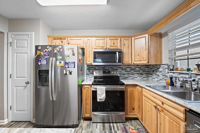 5590 Meadow Creek Pl, Gulf Breeze, FL 32563 - kitchen with appliances with stainless steel finishes, light wood-type flooring, decorative backsplash, light countertops, and a textured ceiling
