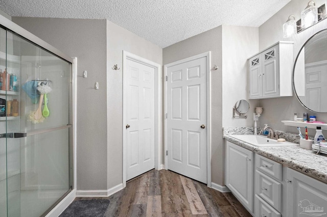 5590 Meadow Creek Pl, Gulf Breeze, FL 32563 - full bath with a stall shower, vanity, wood finished floors, and a textured ceiling