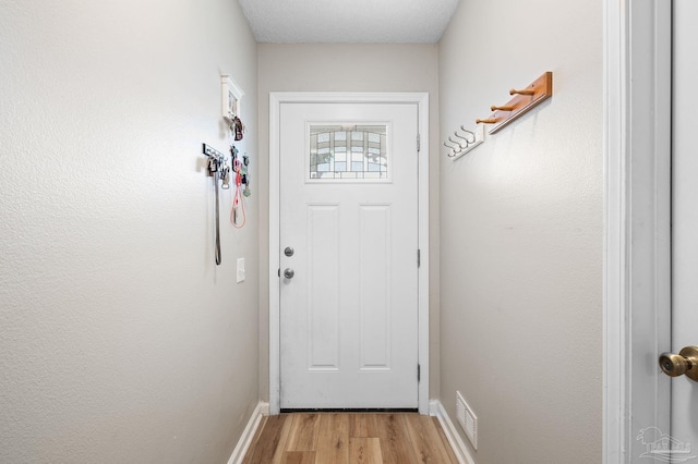 5590 Meadow Creek Pl, Gulf Breeze, FL 32563 - doorway to outside featuring light wood finished floors and baseboards