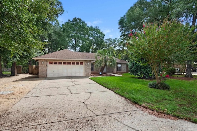 single story home featuring a garage and a front yard