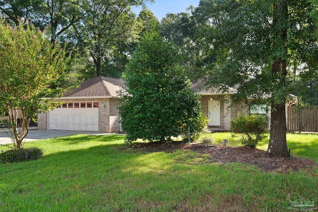 view of front of property with a front yard and a garage