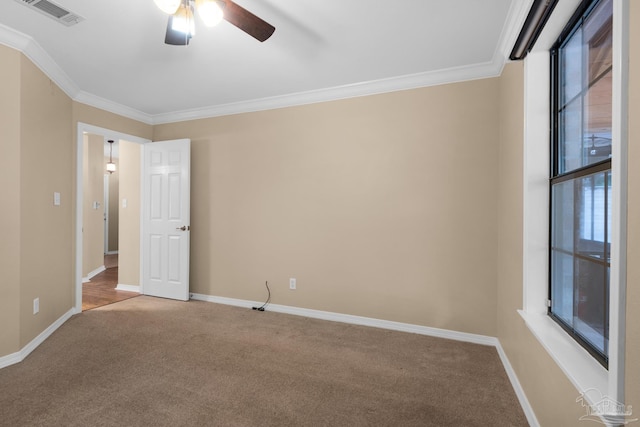 carpeted empty room featuring crown molding and ceiling fan