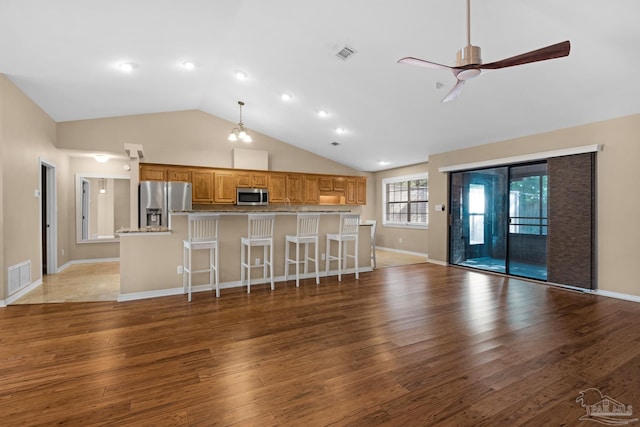 unfurnished living room with high vaulted ceiling, ceiling fan, and dark wood-type flooring