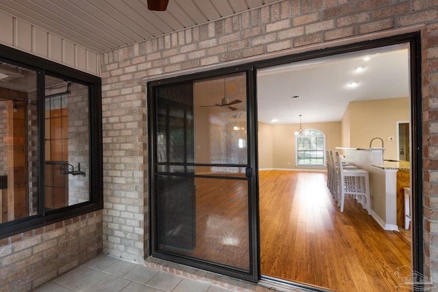 entrance to property featuring ceiling fan