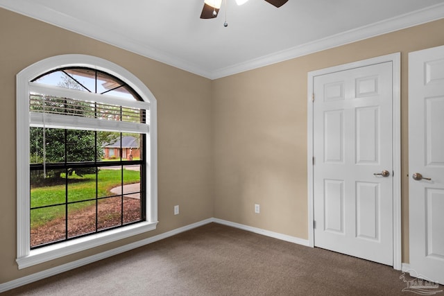 carpeted empty room with ornamental molding and ceiling fan