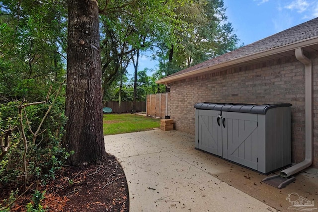 view of side of home with a patio and a yard