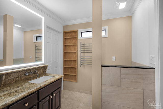 bathroom featuring radiator heating unit, built in features, vanity, and crown molding