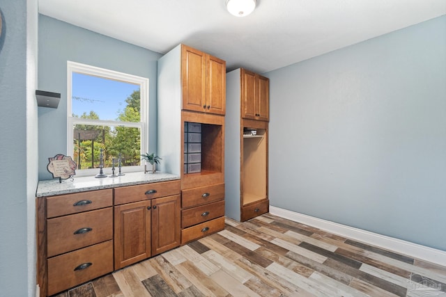 kitchen featuring light stone counters and light hardwood / wood-style floors