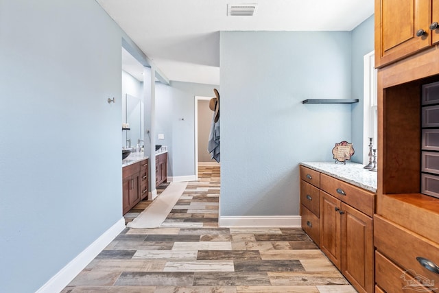 interior space featuring hardwood / wood-style flooring and light stone countertops