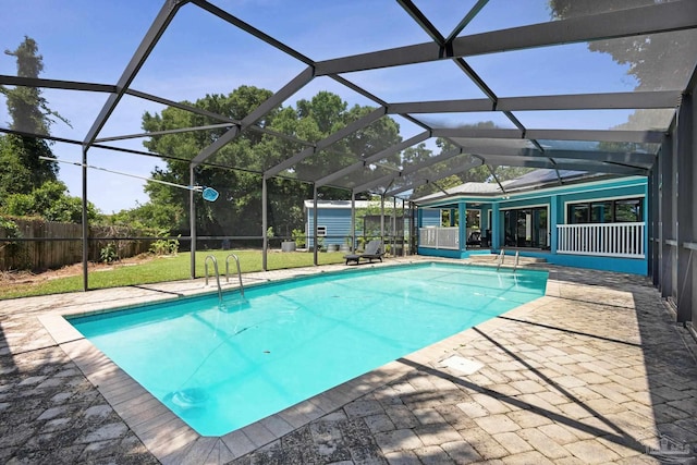 view of pool featuring a patio area, a lanai, and a yard