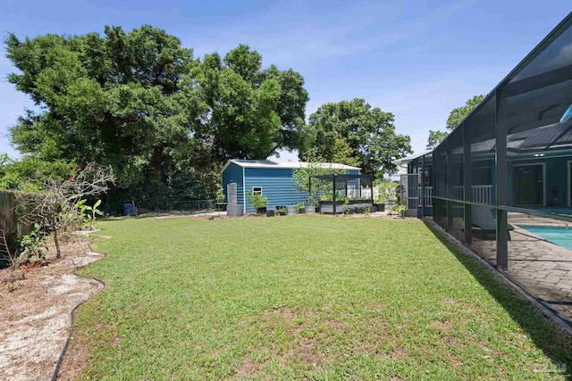 view of yard with a patio, a storage shed, and a lanai