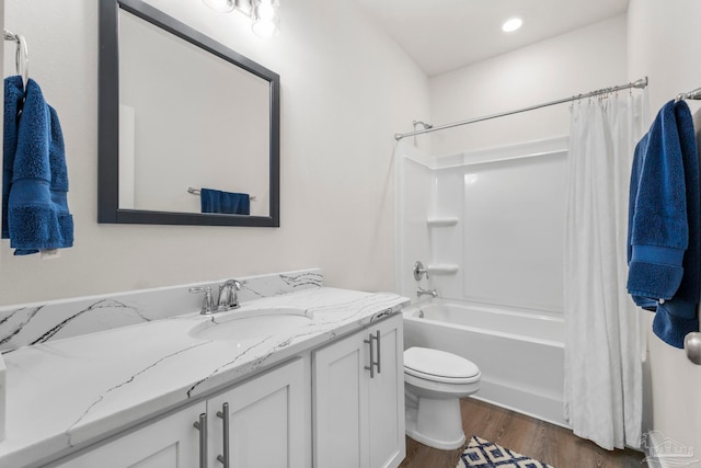 full bathroom with toilet, vanity, shower / tub combo, and hardwood / wood-style flooring