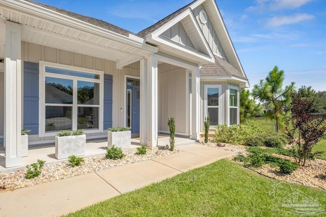 entrance to property with a lawn