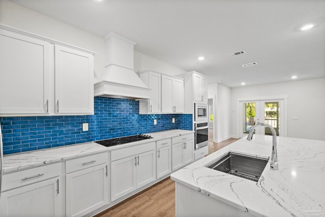 kitchen with white cabinetry, sink, and appliances with stainless steel finishes