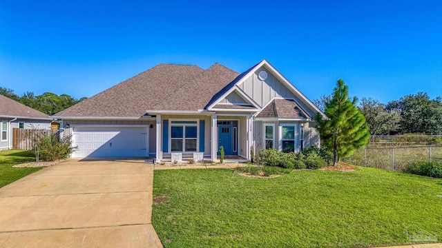 view of front of property featuring a front yard and a garage