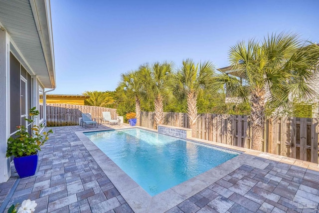 view of pool with pool water feature and a patio