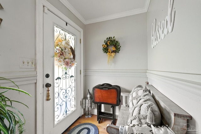 foyer entrance featuring ornamental molding and light hardwood / wood-style flooring