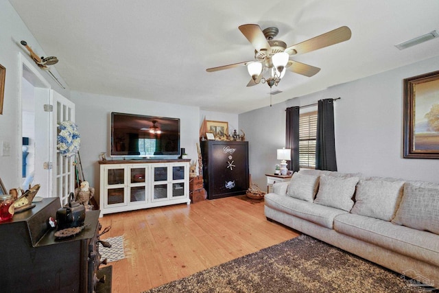 living room featuring ceiling fan and light hardwood / wood-style floors