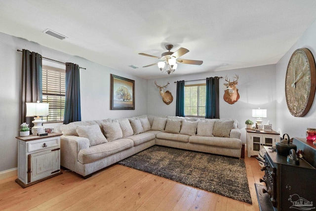 living room featuring light wood-type flooring and ceiling fan