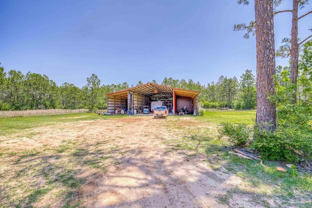 view of yard with a carport and an outdoor structure