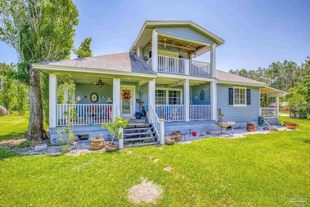 view of front of home featuring a balcony, a porch, and a front lawn