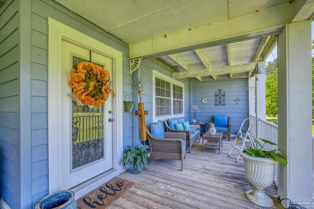 wooden deck with outdoor lounge area and a porch