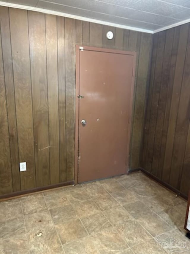 entryway with wood walls